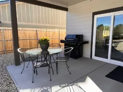 a view of a dining room with furniture large windows and wooden floor