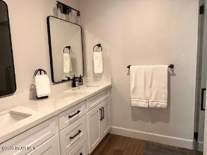 a bathroom with a double vanity sink and mirror