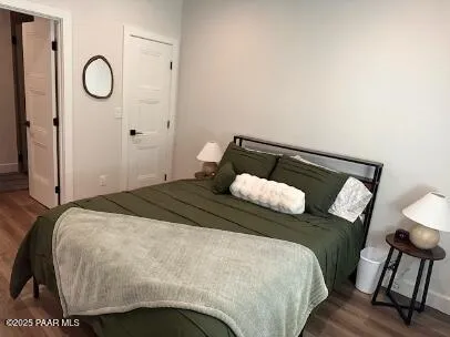 a bedroom with a bed and table chair