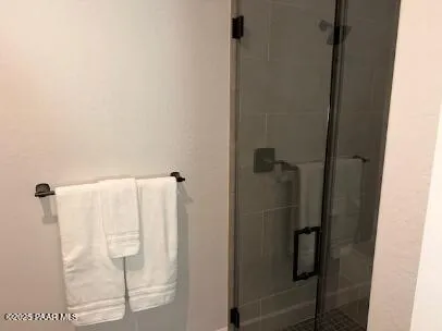 a bathroom with a glass shower door