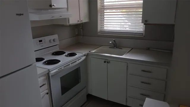 a kitchen with a stove and a sink