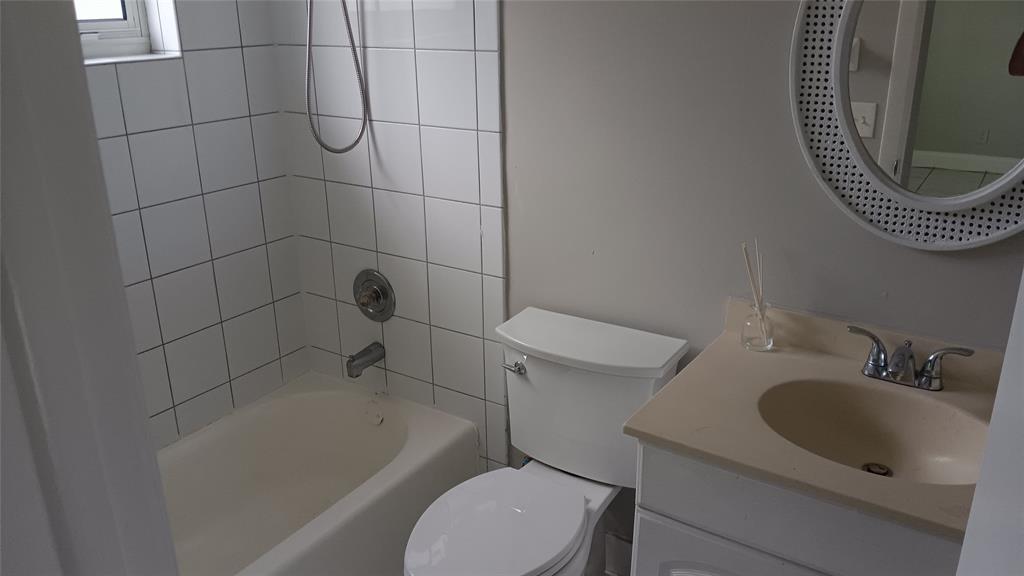 2121 North Ocean Boulevard, Unit 3 Fort Lauderdale, FL 33305 - Photo 8 of 12 a bathroom with a sink a toilet and bathtub