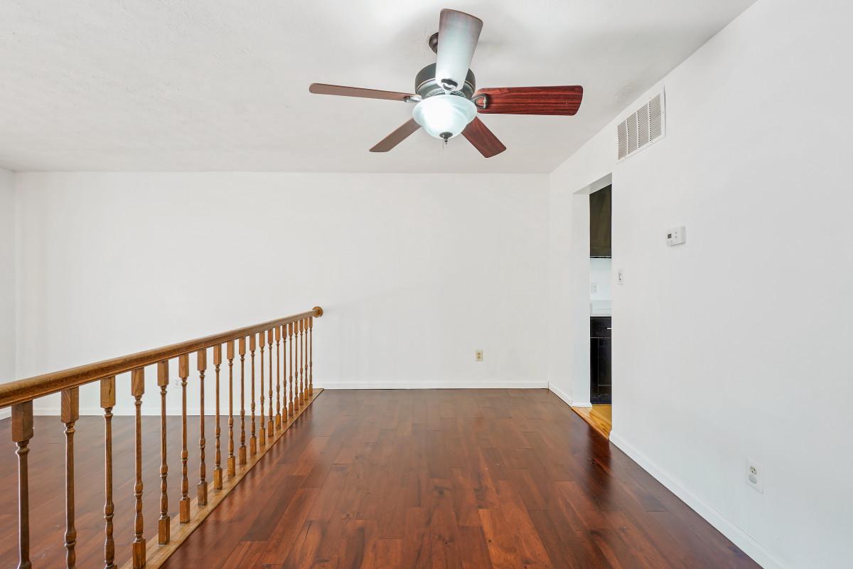 35 Bellfalls Way Nottingham, MD 21236 - Photo 8 of 30 a view of a hallway with wooden floor and a ceiling fan