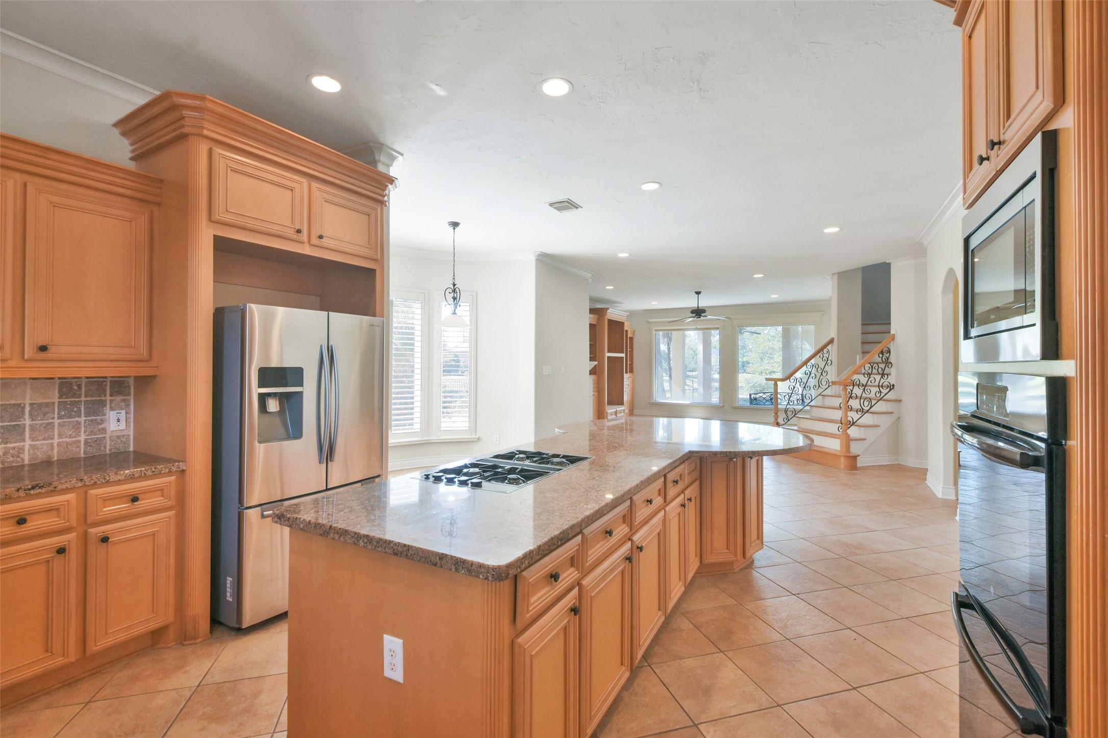 8114 Hideaway Lake Circle Spring, TX 77389 - Photo 12 of 50 a kitchen with stainless steel appliances kitchen island granite countertop a sink refrigerator and cabinets