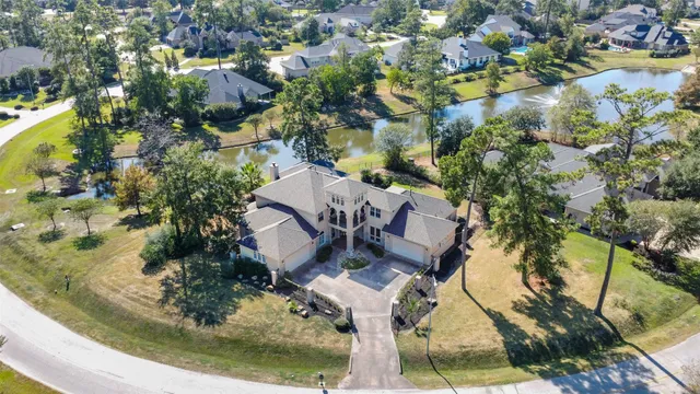 an aerial view of a house with a garden and trees