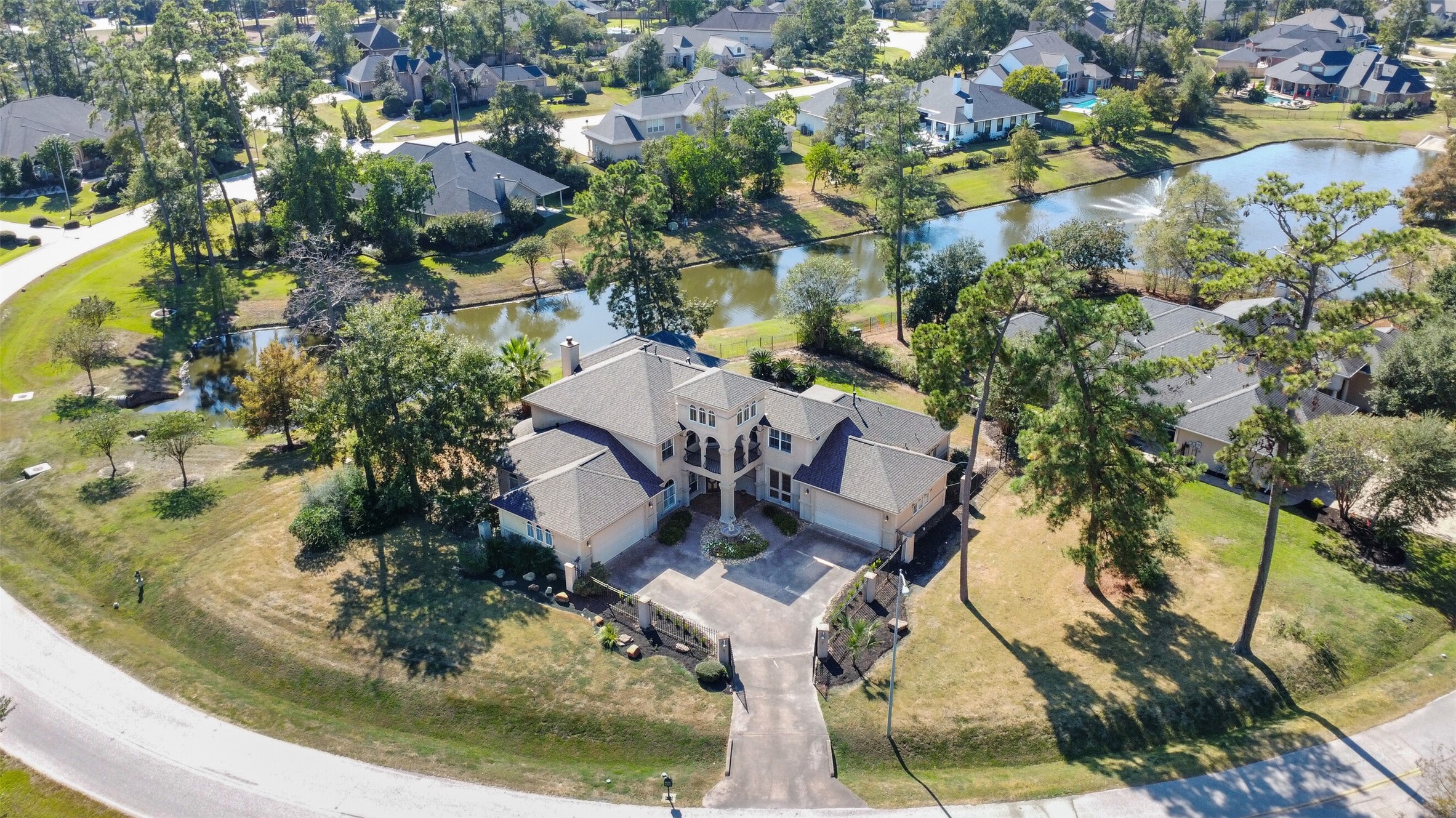 8114 Hideaway Lake Circle Spring, TX 77389 - Photo 2 of 50 an aerial view of a house with a garden and trees