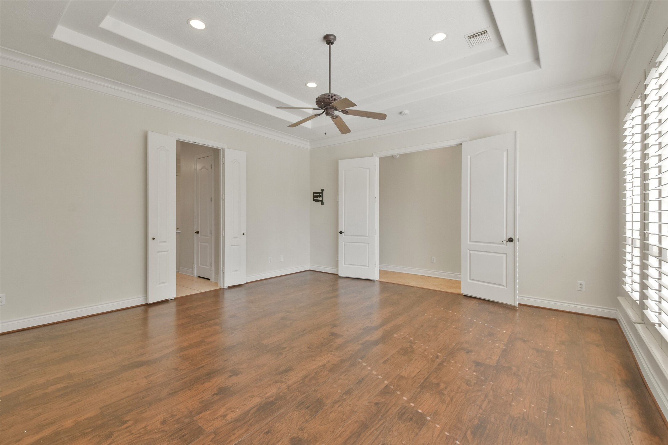 8114 Hideaway Lake Circle Spring, TX 77389 - Photo 21 of 50 an empty room with wooden floor ceiling fan and windows