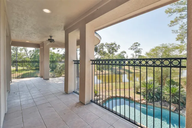a view of a house with swimming pool next to a yard