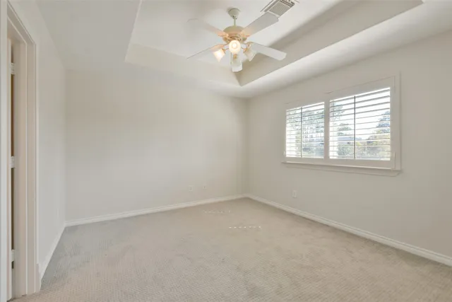 a living room with patio furniture and a floor to ceiling window