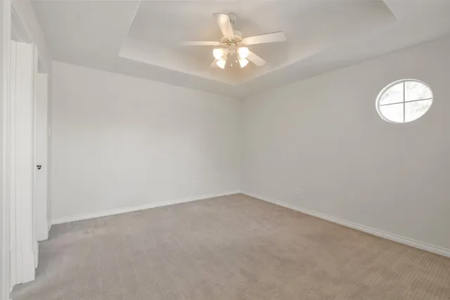 an aerial view of residential houses with outdoor space and trees