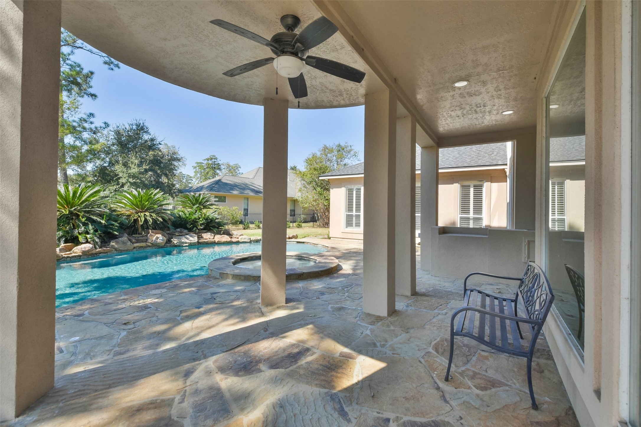8114 Hideaway Lake Circle Spring, TX 77389 - Photo 44 of 50 a living room with patio furniture and a floor to ceiling window