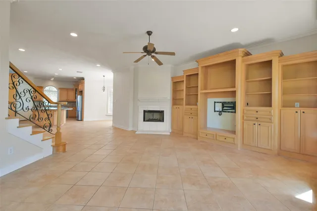 a kitchen with stainless steel appliances kitchen island granite countertop a sink refrigerator and cabinets