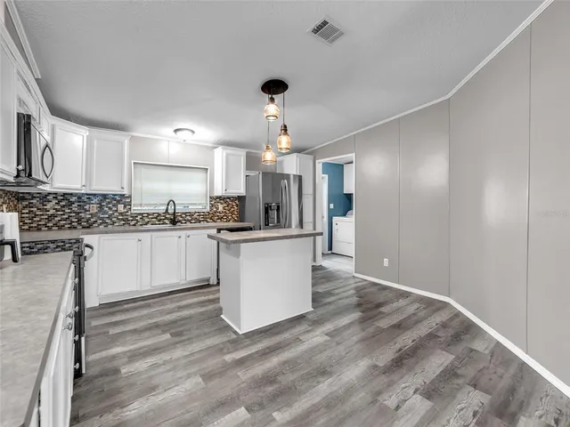 a kitchen with a sink stainless steel appliances and cabinets