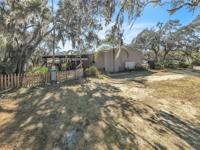 a view of a house with yard and sitting area