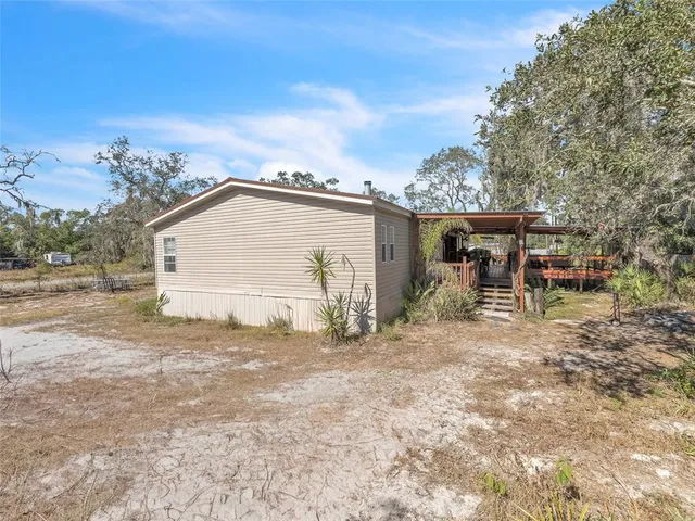 a backyard of a house with table and chairs