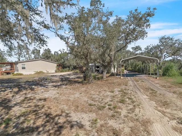 a view of a house with a tree in the background