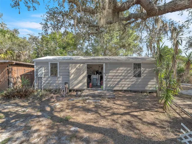 a storage room with lots of clutter and chairs
