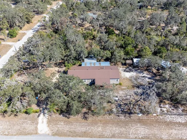 a view of a yard with large trees