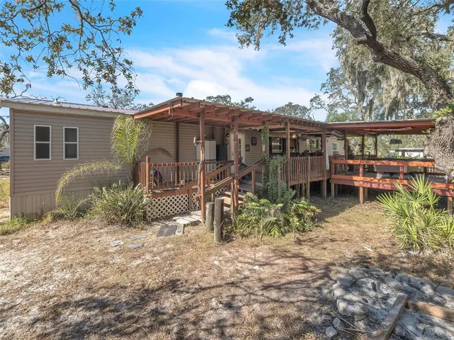 front view of a house with a yard and potted plants