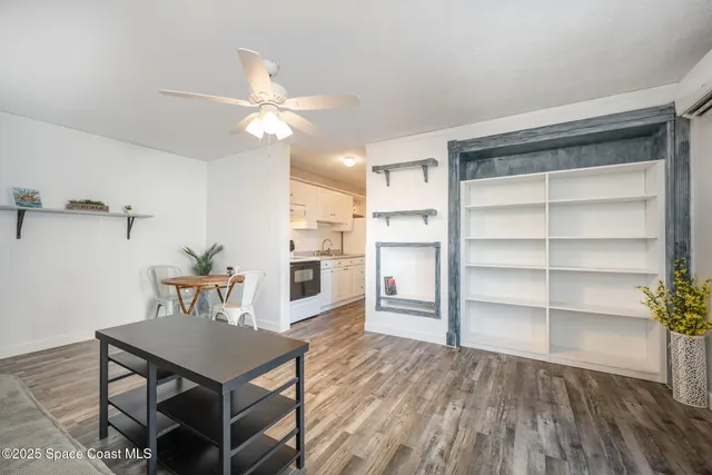 a view of a dining room with furniture and wooden floor