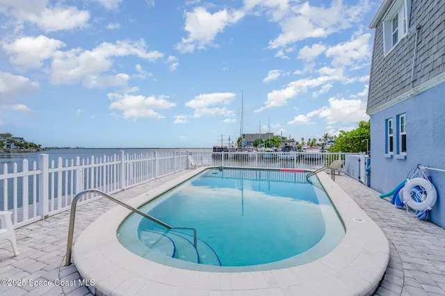 a view of a swimming pool with a lounge chair