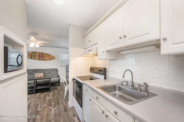 a kitchen with stainless steel appliances a sink and cabinets