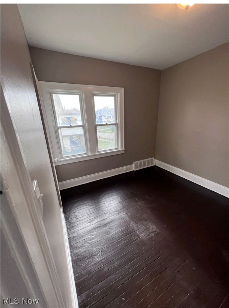 875-877 Paxton Road Cleveland, OH 44108 - Photo 9 of 18 Empty room with dark hardwood / wood-style floors