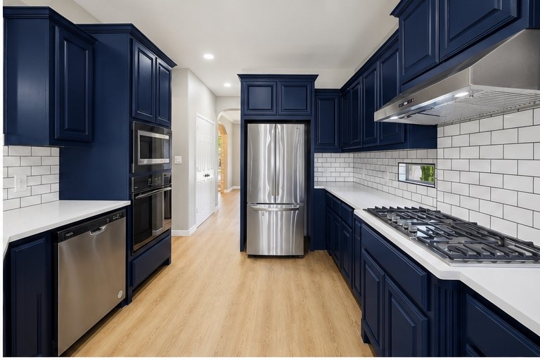 7324 Moon Rock Road Austin, TX 78739 - Photo 8 of 30 a kitchen with stainless steel appliances granite countertop a stove a refrigerator and wooden cabinets