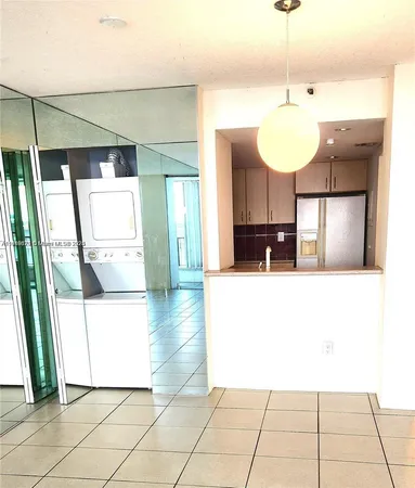 a view of a kitchen with a sink and a chandelier