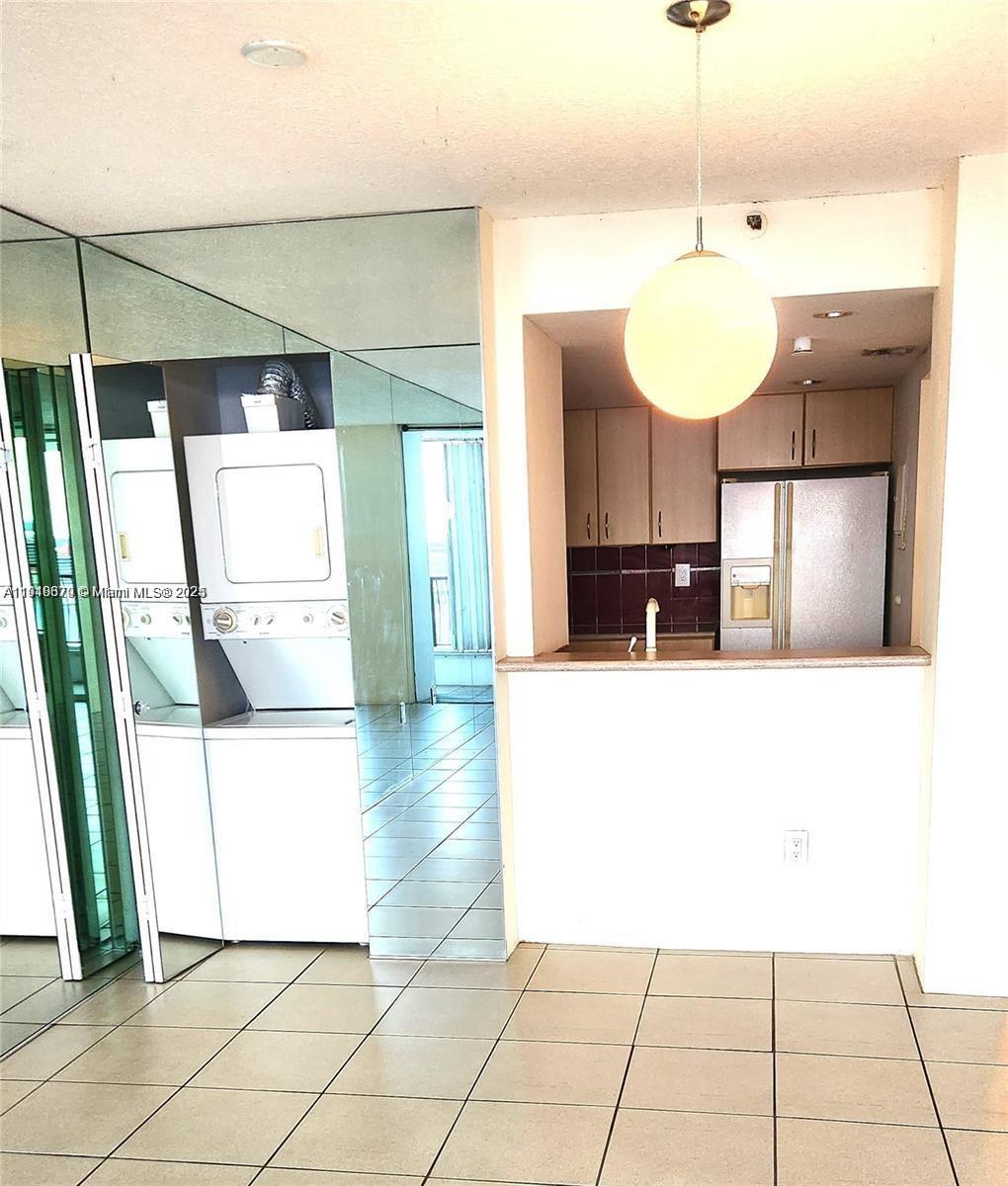 555 Northeast 15th Street, Unit 23J Miami, FL 33132 - Photo 5 of 20 a view of a kitchen with a sink and a chandelier