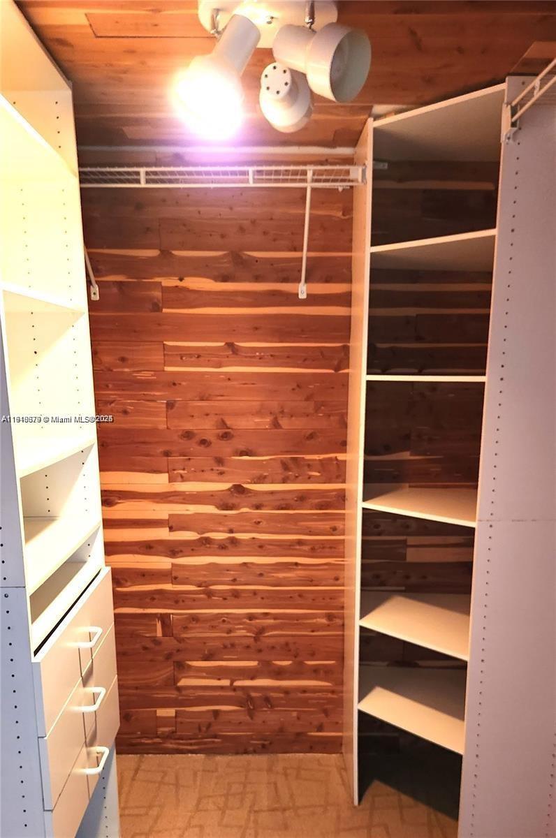 555 Northeast 15th Street, Unit 23J Miami, FL 33132 - Photo 8 of 20 a view of walk in closet with empty racks