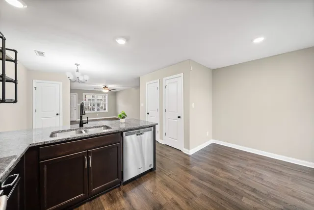 a kitchen with granite countertop a sink and cabinets