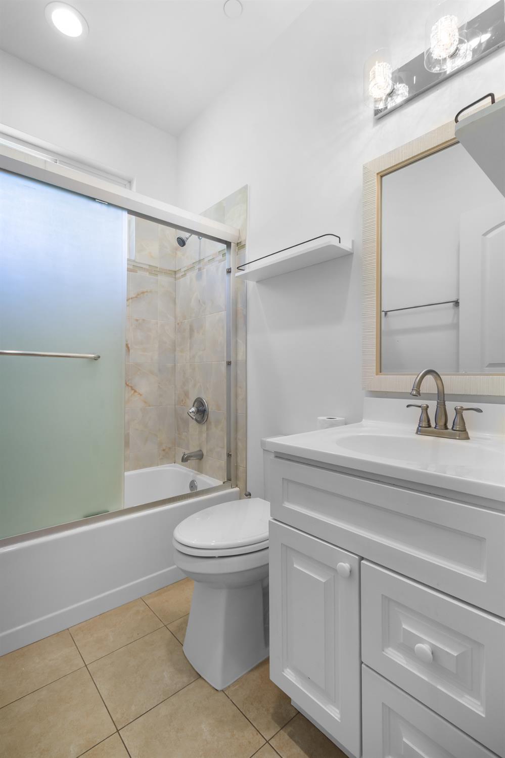 6404 Sylvan Road Citrus Heights, CA 95610 - Photo 11 of 20 a bathroom with a sink a toilet and shower