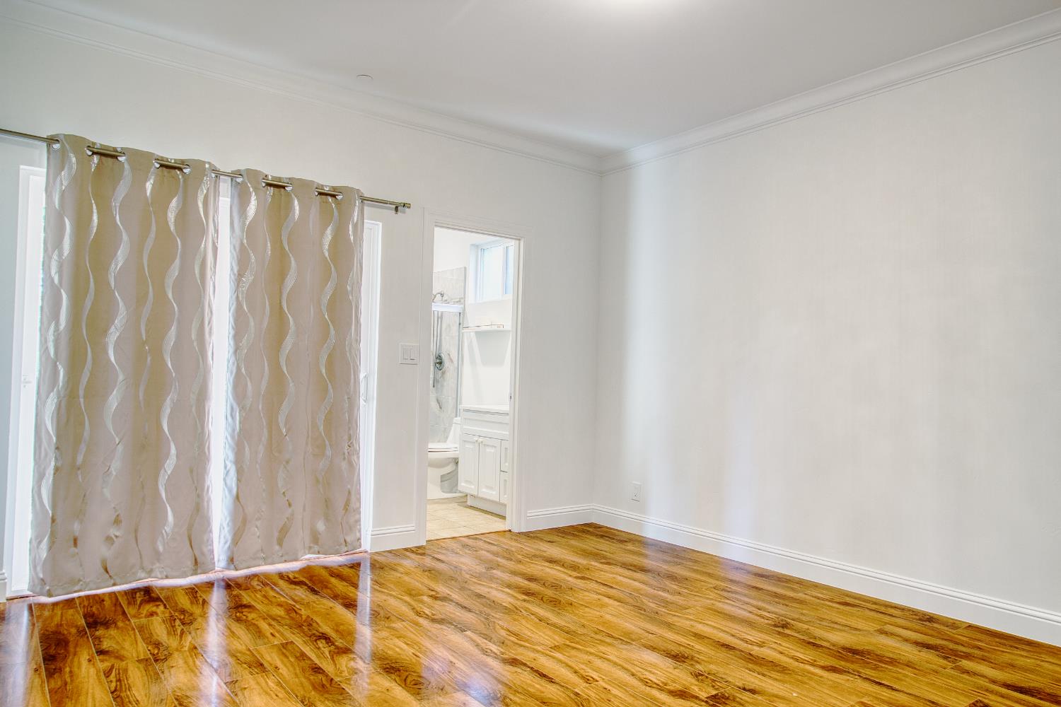 6404 Sylvan Road Citrus Heights, CA 95610 - Photo 12 of 20 a view of a bedroom with wooden floor and a shower