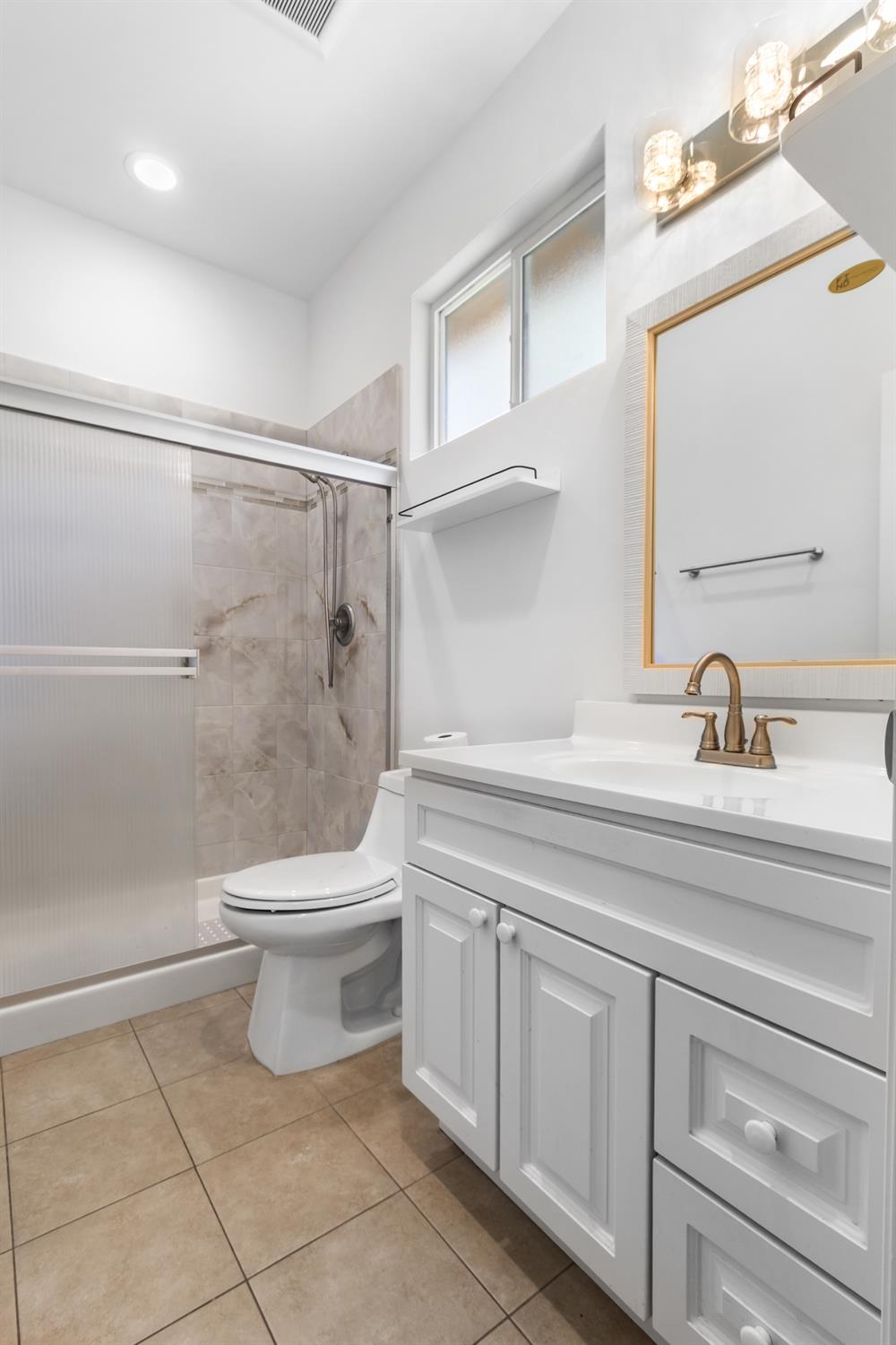 6404 Sylvan Road Citrus Heights, CA 95610 - Photo 13 of 20 a bathroom with a sink a toilet and shower