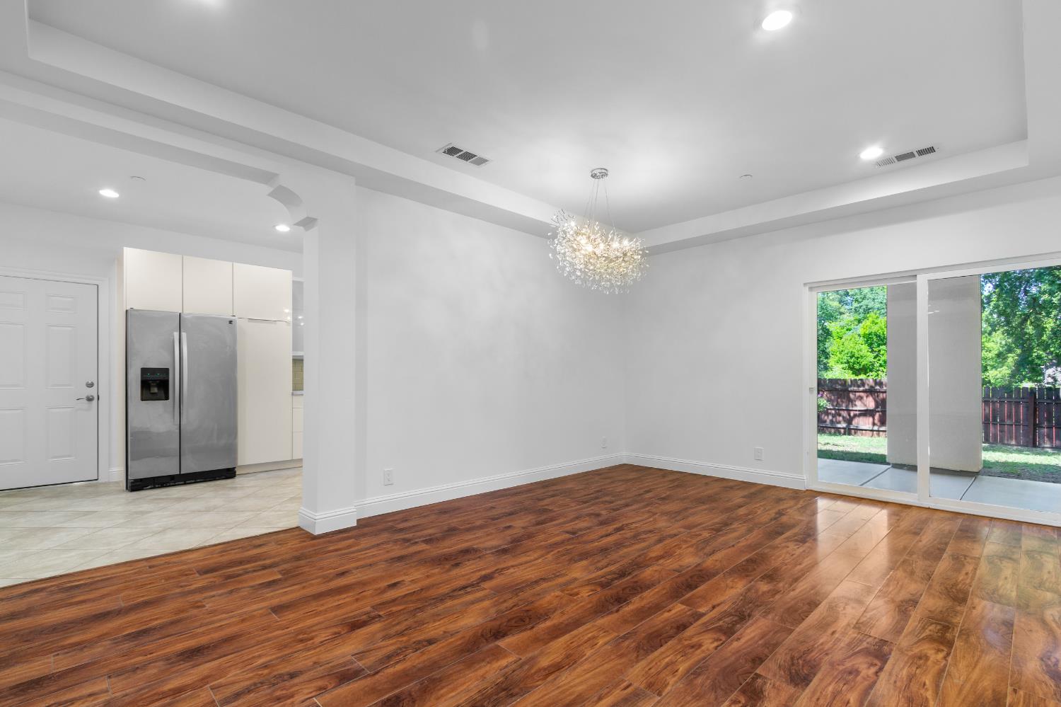 6404 Sylvan Road Citrus Heights, CA 95610 - Photo 9 of 20 a view of an empty room with wooden floor and a window