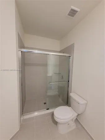 a bathroom with a toilet and shower