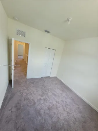 an empty room with an entrance to other room