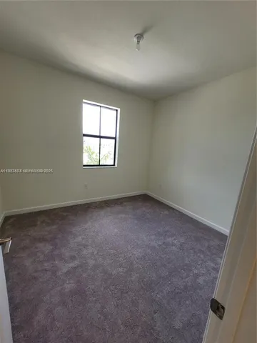 an empty room with a empty space and windows