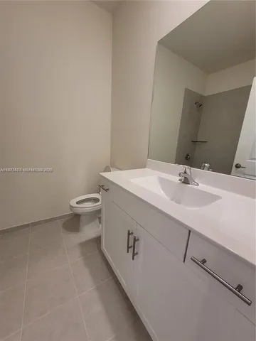 a bathroom with a sink a toilet and mirror
