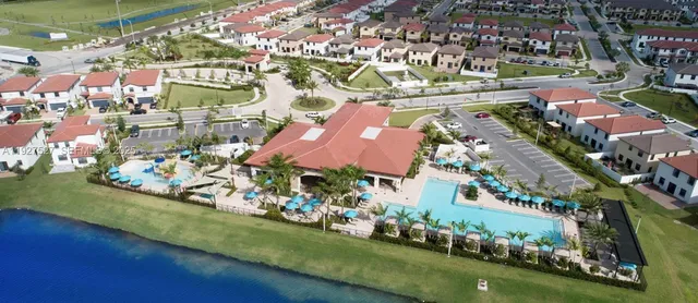 an aerial view of residential houses with outdoor space and swimming pool