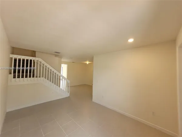 a view of staircase with white walls