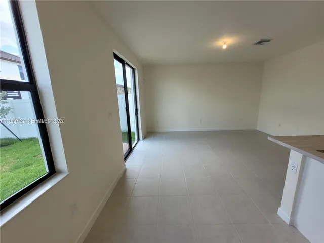 an empty room with windows and entrance