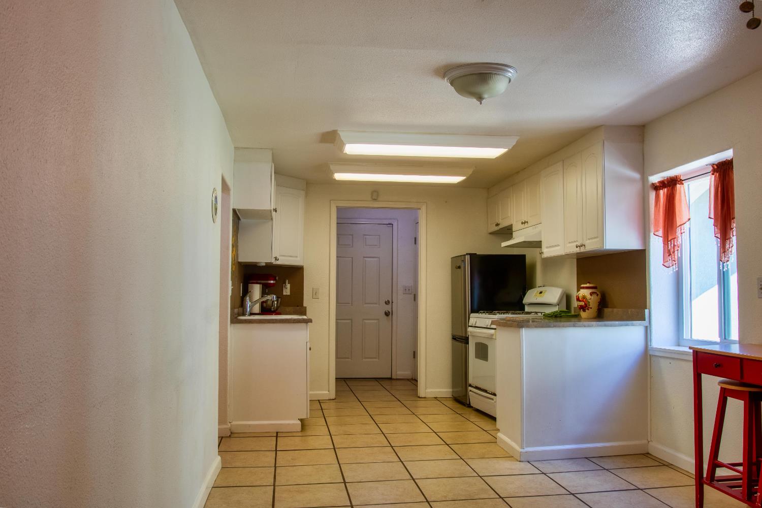 1639 Alpine Road Stockton, CA 95215 - Photo 50 of 96 a kitchen with stainless steel appliances a stove a refrigerator and a sink