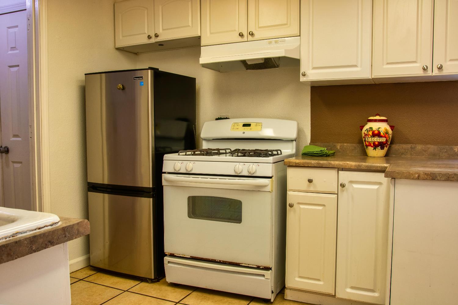 1639 Alpine Road Stockton, CA 95215 - Photo 61 of 96 a kitchen with stainless steel appliances white cabinets and a refrigerator