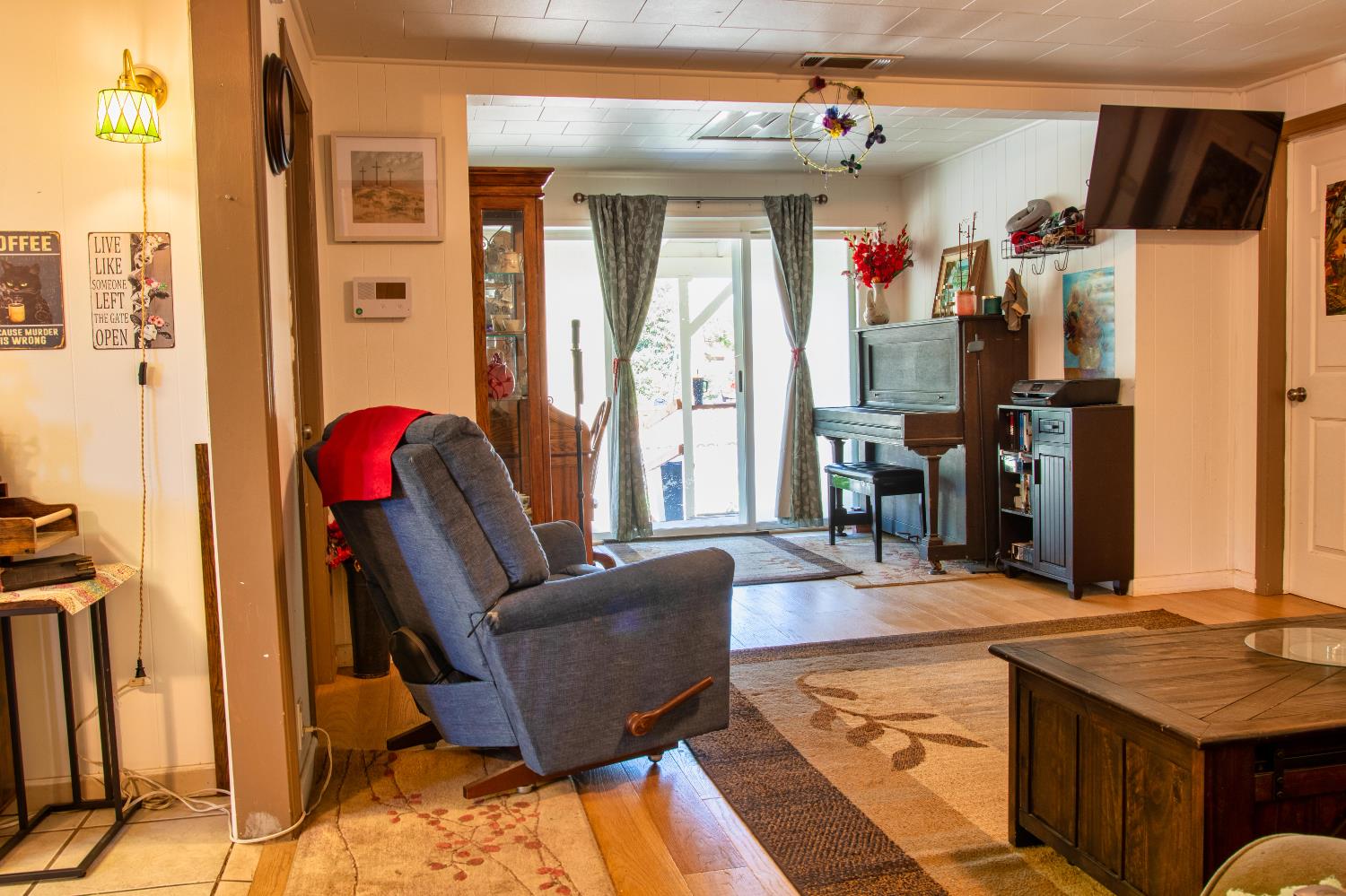 1639 Alpine Road Stockton, CA 95215 - Photo 66 of 96 a living room with furniture a flat screen tv and a refrigerator