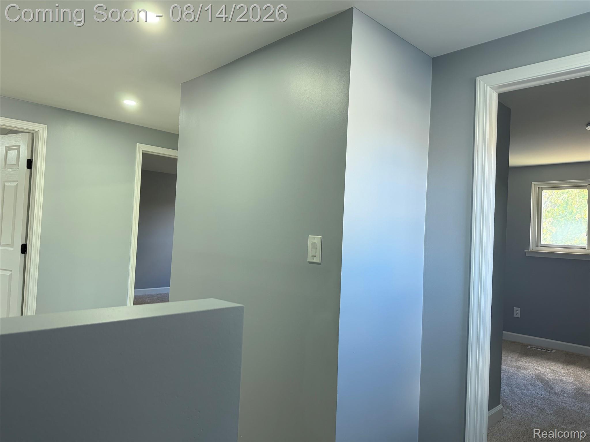 20698 Coachwood Road Riverview, MI 48193 - Photo 21 of 37 Hallway featuring recessed lighting, a neutral gray color palette, white trim, and carpeted flooring in the adjacent room