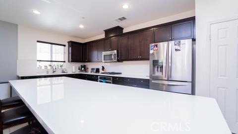 20636 Spring Street Riverside, CA 92507 - Photo 3 of 9 a kitchen with stainless steel appliances a refrigerator sink and microwave