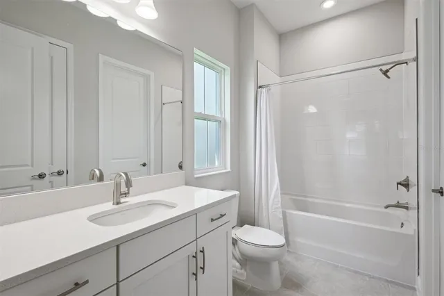 a bathroom with a sink toilet tub and shower