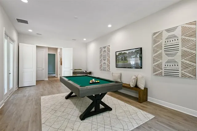 a room with furniture pool table and window
